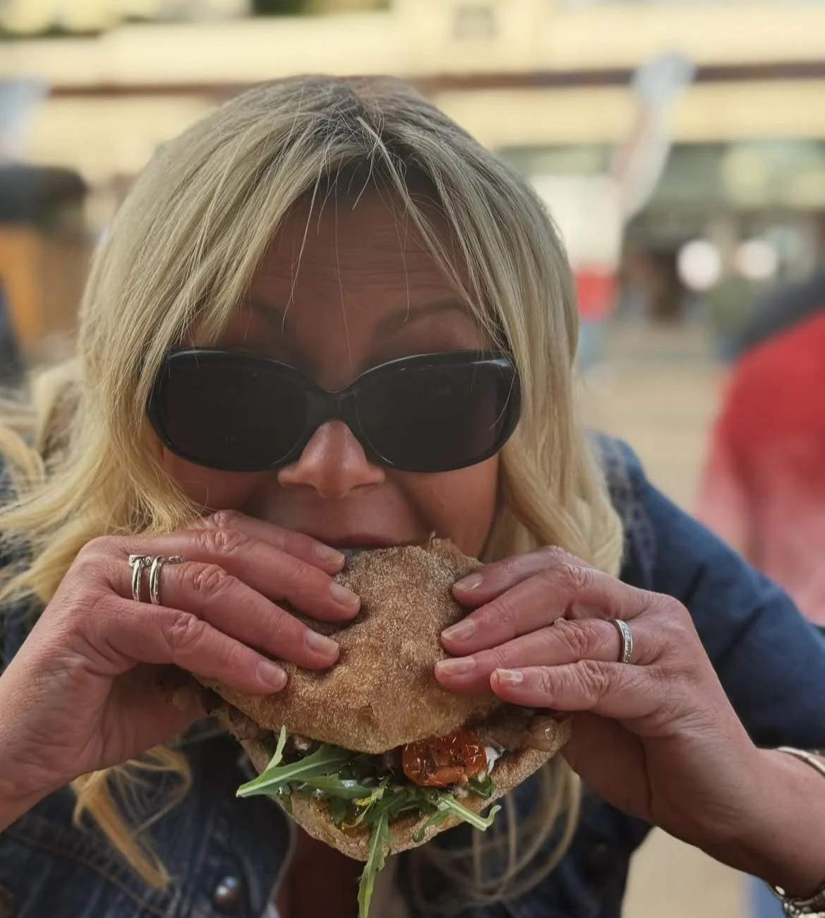 Lady in sunglasses eating burger at Eat Street Cumbria Event